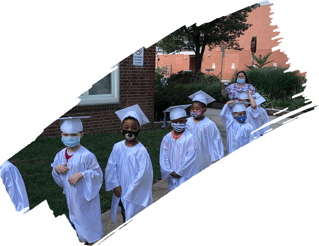 A group of kids in graduation gowns and hats.